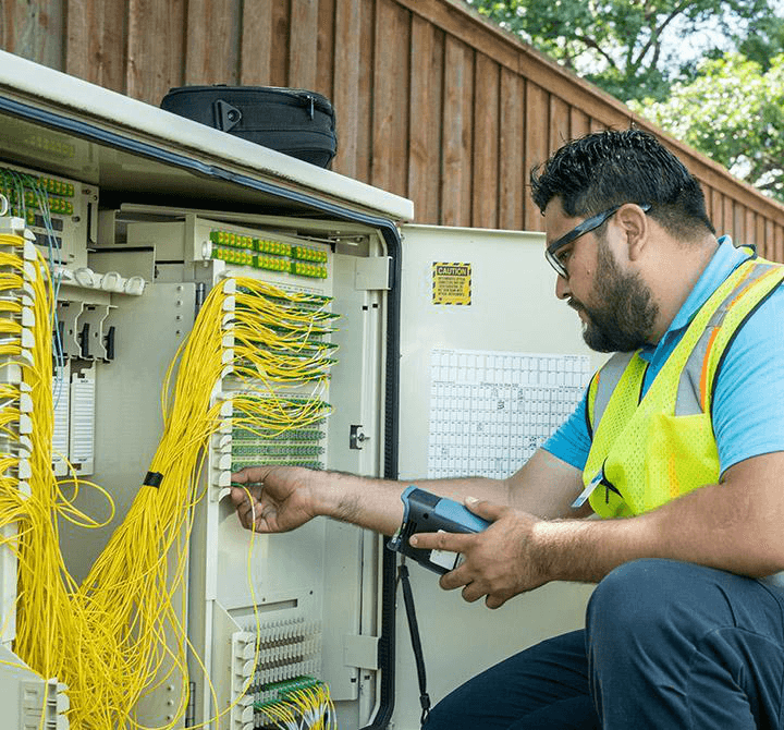 Field technician auditing a network cabinet