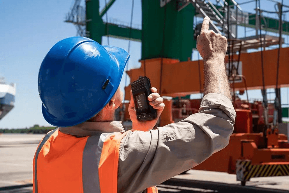 Construction worker using field communication equipment